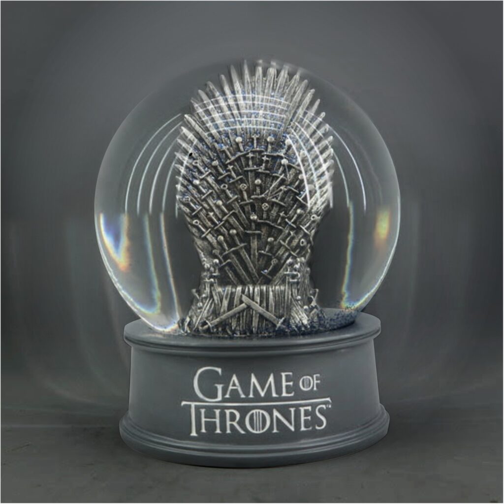 A Game of Thrones custom created snowglobe. Inside the globe is the Iron Throne from the TV show. The base is grey and says "Game of Thrones" on it