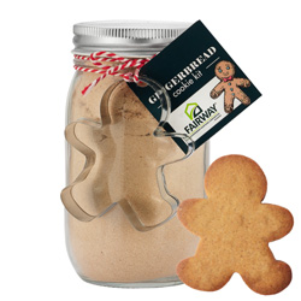 A mason jar filled with cookie mix, a gingerbread man stands next to it