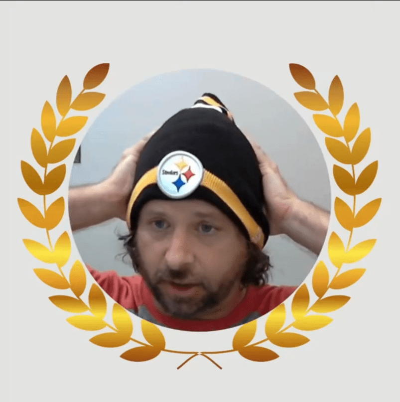 Inside of a medal laurel wreath is a picture of Sonic Promos president Seth Weiner. He's wearing a Pittsburgh Steelers beanie