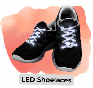 Pair of black athletic sneakers with glowing LED laces, shown against an orange background with a 'LED Shoelaces' label.