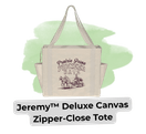 Beige canvas tote bag with black handles and a vintage illustration, labeled 'Jeremy™ Deluxe Canvas Tote' against a light green background.