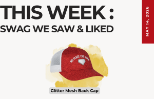 Weekly swag roundup cover featuring a red glitter mesh-back cap with 'No Place Like Home' on a yellow splash background. Date May 14, 2016 on a red ribbon.
