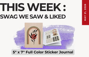 Graphic announcing this week's swag highlight: a 5x7 full-color sticker journal beside a sticker book on a purple brushstroke background (May 21, 2026).