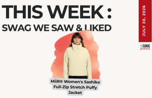 Promotional image: a woman wearing a beige MiiR Women's Sashiko full-zip stretch Puffy Jacket, under the heading 'THIS WEEK: SWAG WE SAW & LIKED' with a red date stripe on the right.