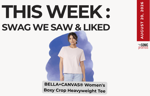 Promotional banner showing a woman in a light pink Bella+Canvas Women's Boxy Crop Heavyweight Tee against a purple backdrop; headline reads 'THIS WEEK: SWAG WE SAW & LIKED' with a red date strip on the right.