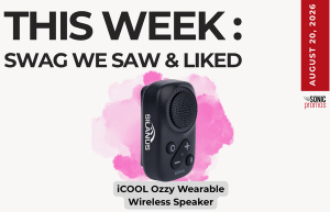 Promotional graphic highlighting the iCOOL Ozzy wearable wireless speaker, set against a pink splash background with bold headline and a red date strip on the right.