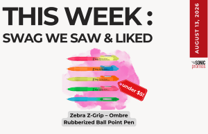 Promo graphic: This Week’s swag feature shows Zebra Z-Grip Ombre Rubberized Ball Point Pens in pastel colors with an “under ” tag and August promo side bar.