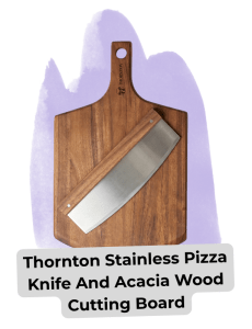 Blog images 13 - Sonic Promos | Custom Promotional Items Wood cutting board with a stainless pizza knife laid diagonally across it; purple background behind the board.